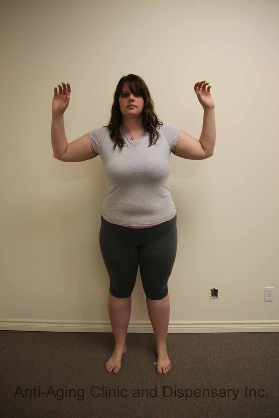 Woman in casual attire posing in a clinic setting