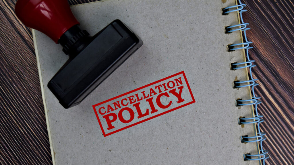 Cancellation policy stamp on notebook beside rubber stamp