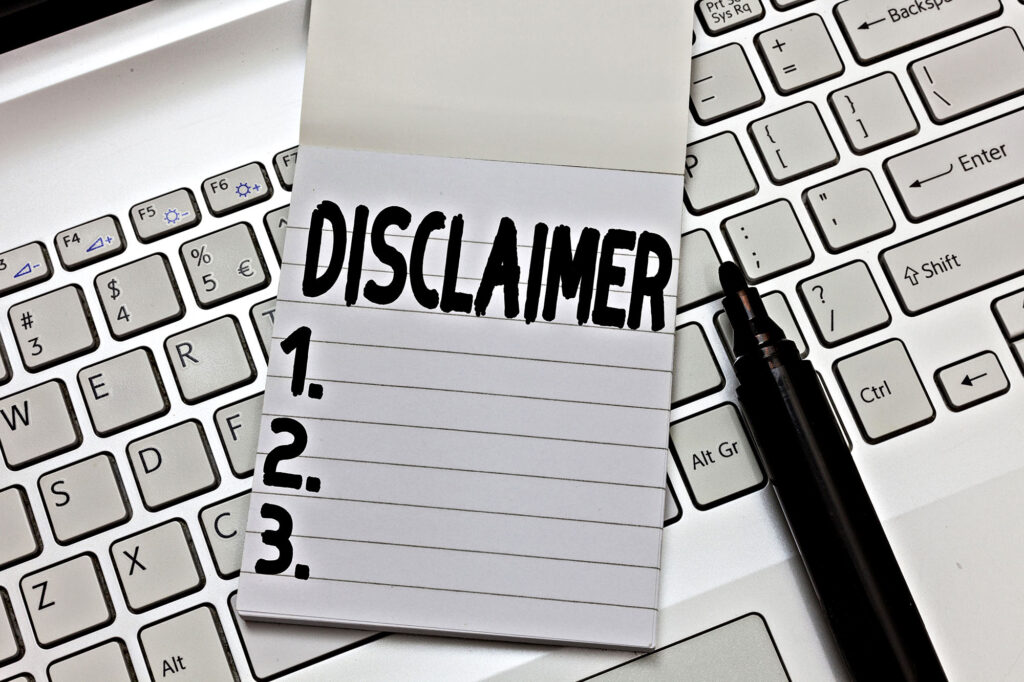 Disclaimer text notepad on computer keyboard