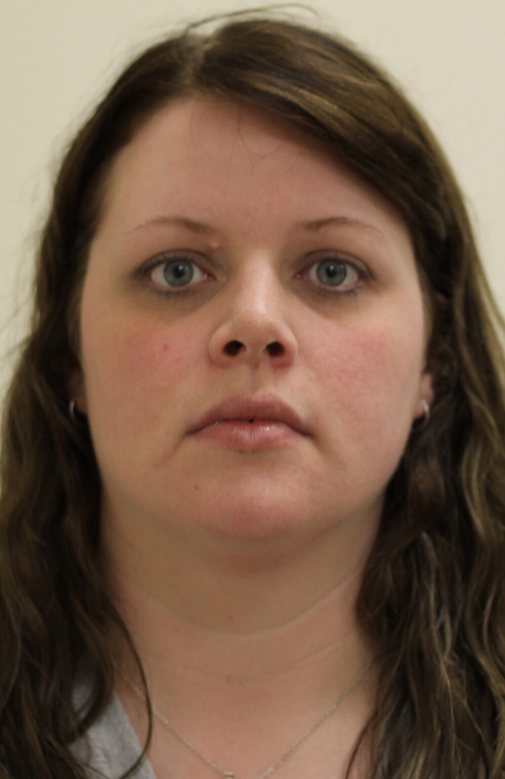 Portrait of a woman with brown hair and blue eyes