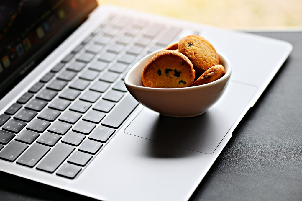 Bowl of cookies on a laptop keyboard