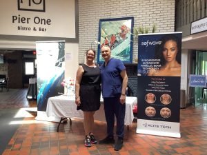Medical professionals posing at Pier One Bistro with Sofwave technology banners