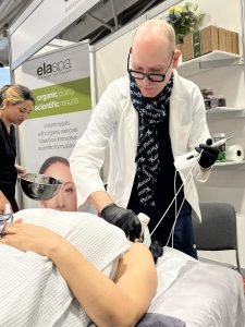 Man performing skincare treatment at a spa with organic products