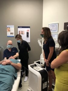 Team consulting during a medical aesthetic treatment session