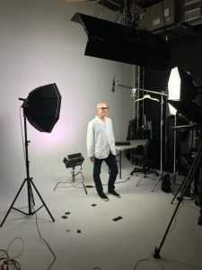 Man in photo studio with lighting equipment
