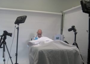 Professional studio setup for a medical photoshoot with lighting and cameras