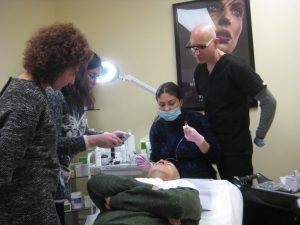 Medical professionals demonstrate cosmetic injection techniques on a patient in clinic setting