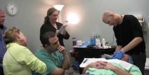 Medical training session with doctors and instructor in clinic room