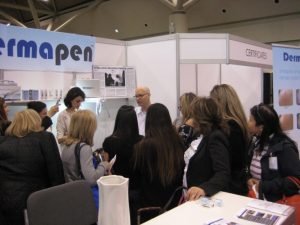 Dermapen booth demonstration at trade show with attendees