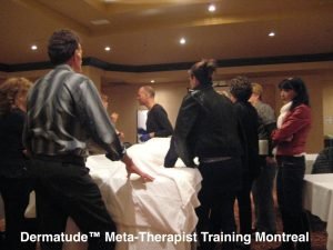 Dermatude Meta-Therapist training session in Montreal with participants gathered around a table