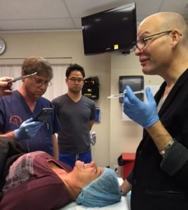 Medical team preparing for cosmetic injection procedure in clinic