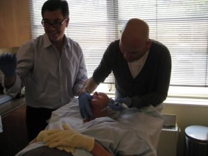 Doctors performing a cosmetic procedure in a clinic