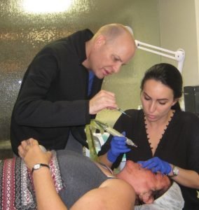 Botox treatment being applied by professionals in clinic
