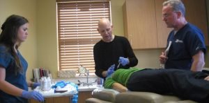 Medical team performing cosmetic procedure in clinic