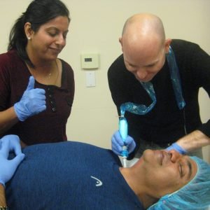 Doctor performs non-invasive cosmetic procedure on a relaxed patient