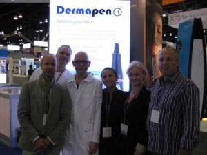 Group at dermatology conference in front of Dermapen booth
