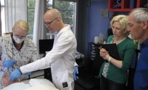 Medical team performing a facial procedure on a patient in a clinic