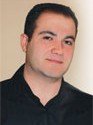 Portrait of a man in a black shirt looking forward