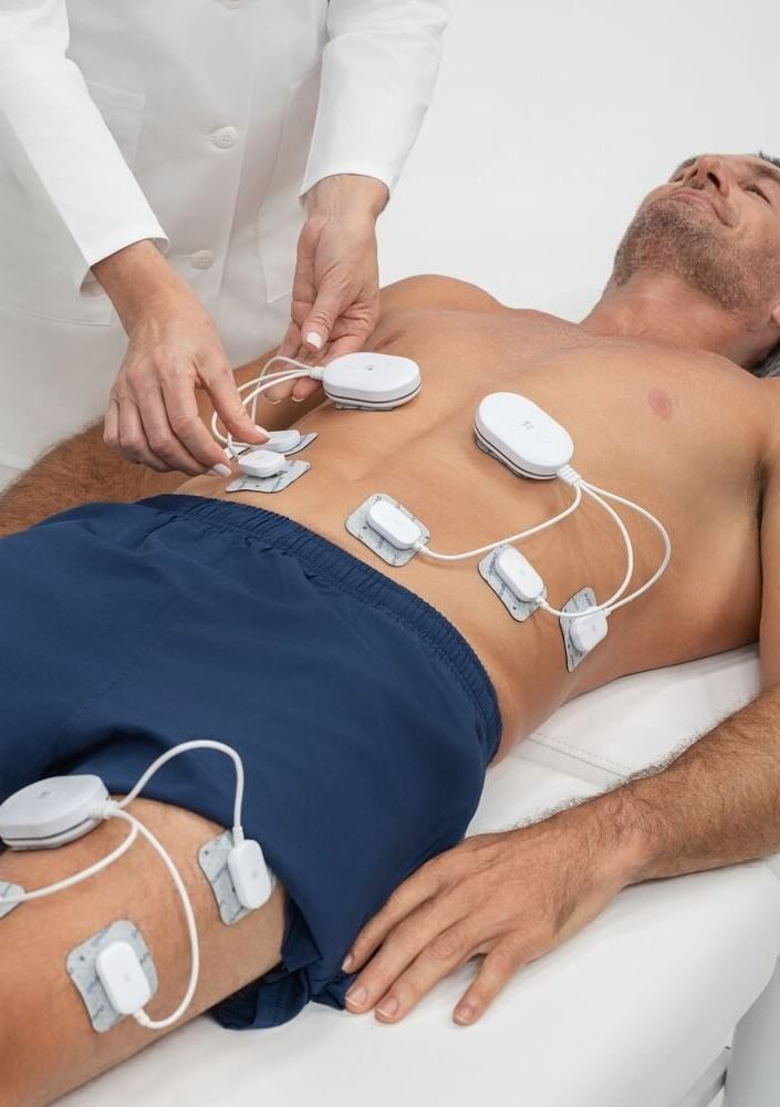 Electrocardiogram electrodes on man's chest for heart monitoring